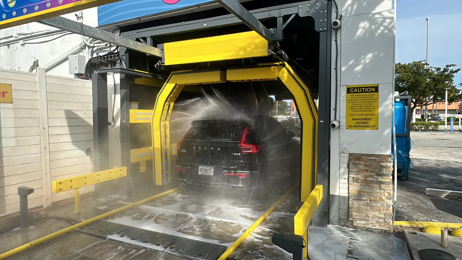 Acrobat 2X arms spraying a black SUV, seen from the side