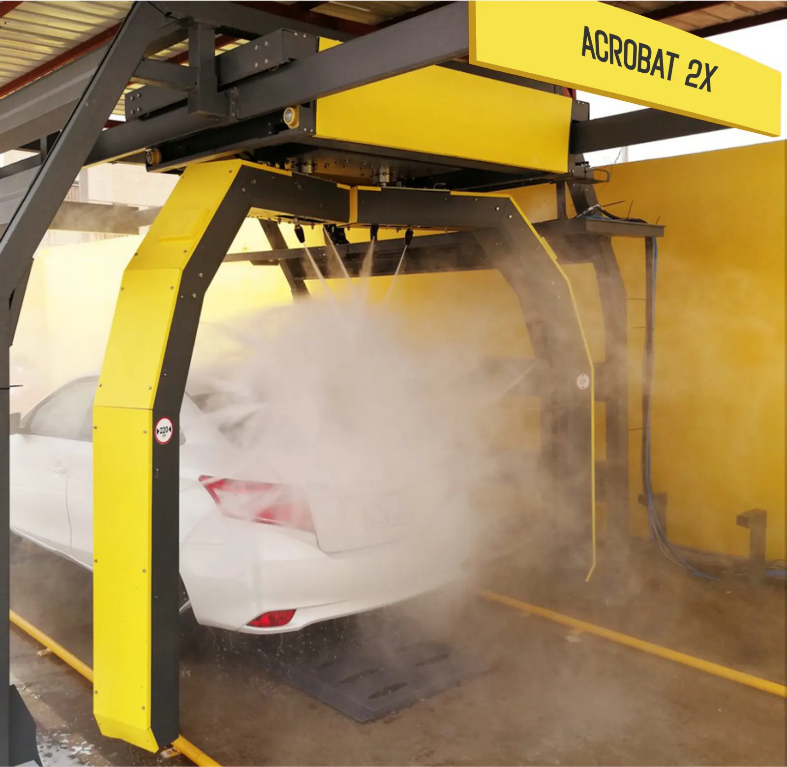 Acrobat 2X touchless arms washing a white car, with the ACROBAT 2X name on the bridge