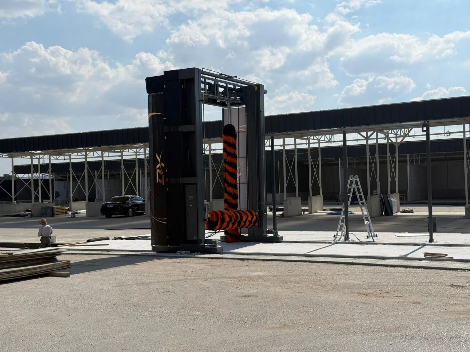 A SUNRISE gantry during installation under a steel canopy